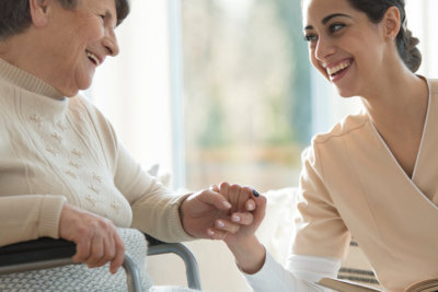 Smiling caregiver taking care of a happy